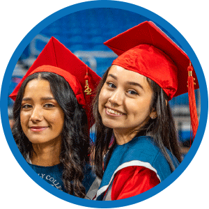 smiling students in graduation caps & gowns
