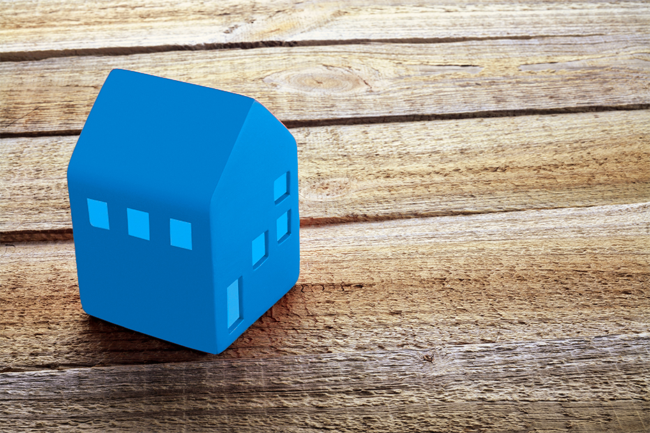 Blue house on a wooden table