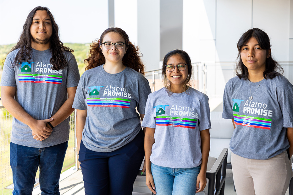 Four smiling students wearing grey t-shirts with the Alamo Promise logo