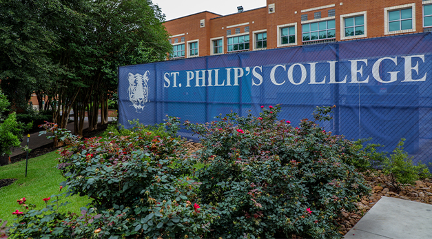 Campus photo with SPC Tiger and St. Philip's College fence wrap